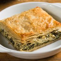 Spanakopita · Crispy phyllo pie filled with baby spinach, dill, and creamy feta.