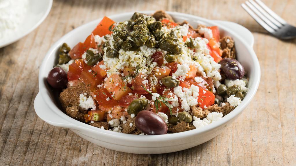 Dakos Salad · Comes with barley rusk, chopped tomatoes, feta, Kalamata olives, and capers. A classic salad from the island of Crete.