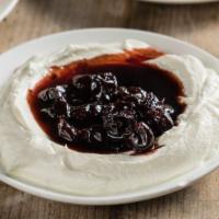 Greek Yogurt · Thick and rich yogurt topped with either honey and walnuts or sour cherry preserves.