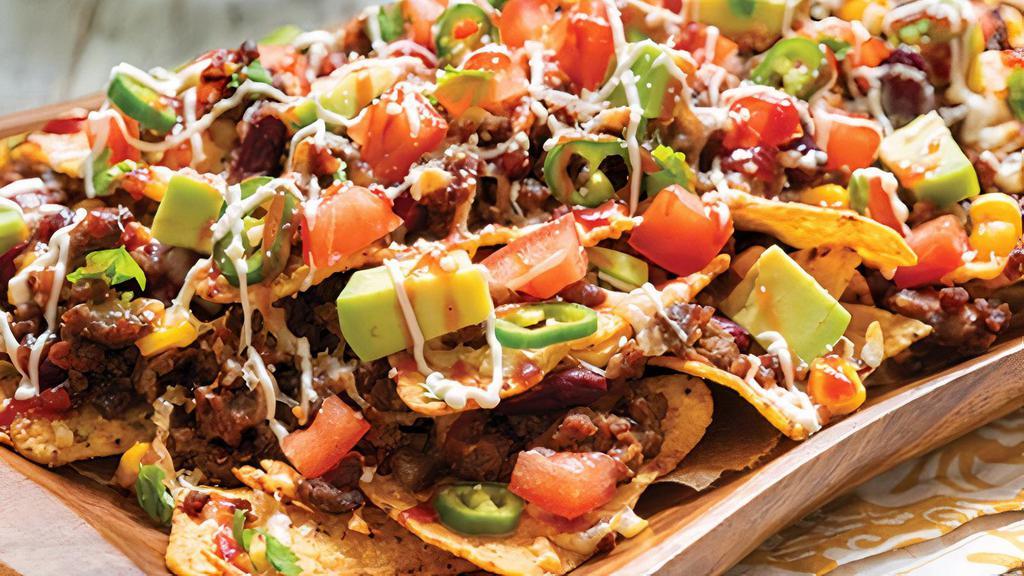 Tequila Nachos · Come with rice, black beans, mixed cheese, lettuce, tomatoes, cream, cheese, and guacamole.