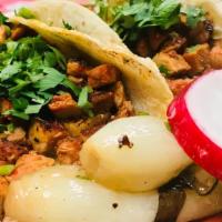 Tacos Al Pastor · Spicy pork with pineapple.