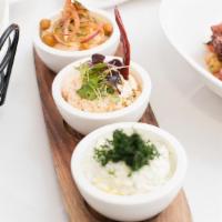 Trio Of Traditional Spreads · tzatziki, spicy feta, and hummus served with 2pcs of pita