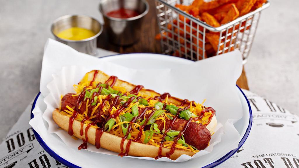 Memphis Dog · Bacon wrapped hot dog, topped with shredded cheese, BBQ sauce and green onions.