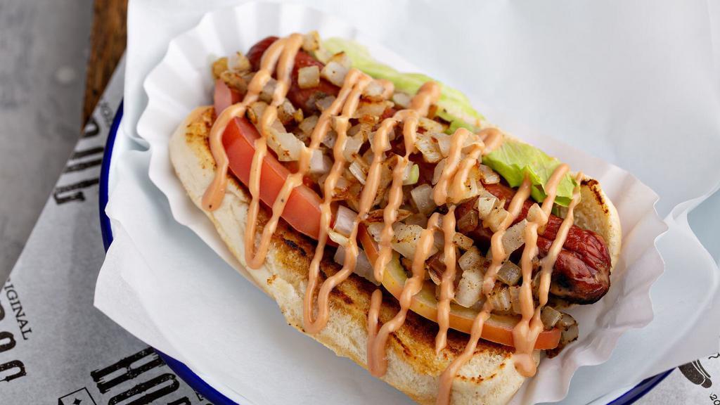 California Baby Dog · Grilled beef dog topped with lettuce, tomatoes, grilled onions, avocado and try me sauce.