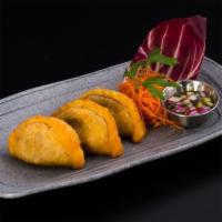 Kra-Pow Puff · Lightly deep-fried pastry puffs filled with minced chicken, string bean, cheese, & basil ser...