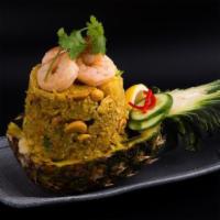 Pineapple Fried Rice · Stir-fried jasmine rice with Shrimp, pineapples, onions, scallions, tomatoes, carrots, curry...