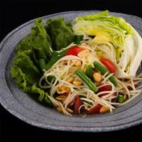 Papaya Salad · Spicy. Shredded green papaya in a disco dance party, tossed with tomatoes, string beans & pe...