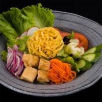 House Salad · A variety of fresh garden greens with tomatoes, cucumbers, onions & fried tofu served with y...
