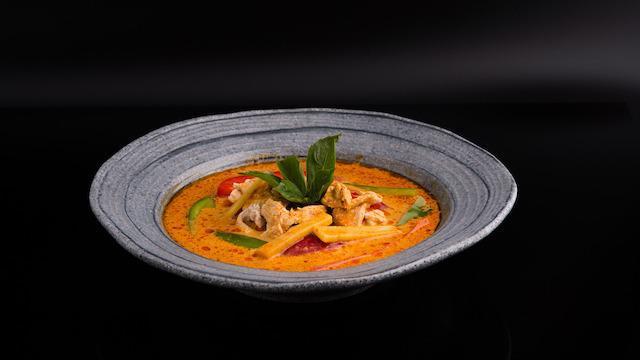 Red Curry · Spicy. Stop! and get this! bell peppers, bamboo shoots & basil leaves simmered in coconut milk with red chili paste, blended with Thai herbs & spices.