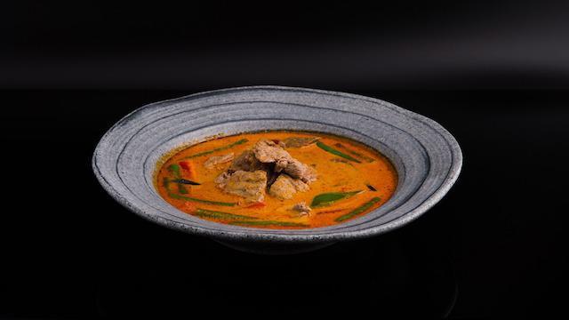 Panang Curry · Spicy. String beans, bell peppers & kaffir lime leaves simmered in coconut milk with panang curry paste blended with Thai herbs & spices.