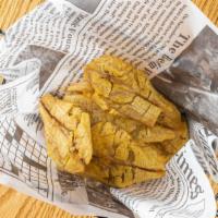 Tostones · Fried plantain slices.