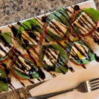 Fresh Caprese Salad · Fresh sliced mozzarella and tomatoes layered with fresh basil then drizzled with balsamic gl...
