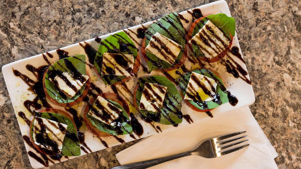 Fresh Caprese Salad · Fresh sliced mozzarella and tomatoes layered with fresh basil then drizzled with balsamic glaze. So deliciously refreshing.