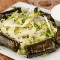 Dolmades · Stuffed grape leaves with rice, cup of tzatziki