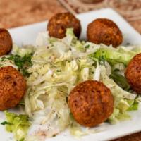 Vegan Greek Meatballs · Plant-based prepared with fresh herbs and spices atop organic mixed greens.