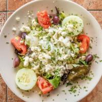 Greek Salad · Lettuce, tomatoes, cucumbers, onions, dolmades, olives and imported Greek feta and our homem...