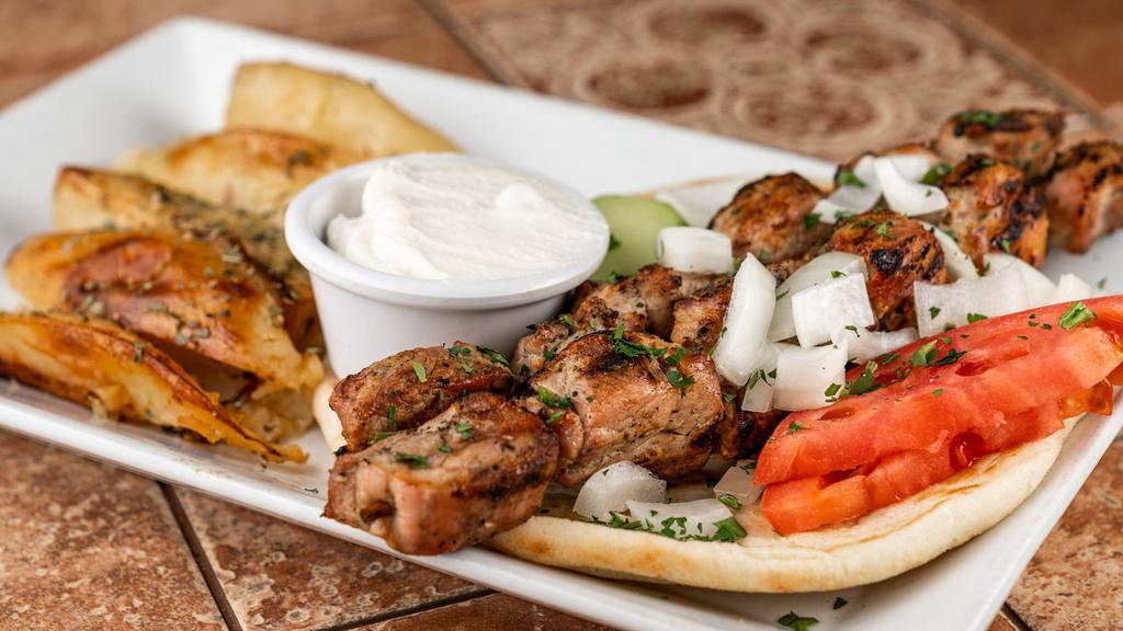 Souvlaki Pork Tenderloin Kebab Platter · 2 skewers. Served with Greek salad, pita bread, tzatziki sauce, garnished with tomato, onions, and cucumber.