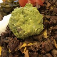 Nachos Steak · Crispy corn tortilla chips smothered with melted cheese, beans, jalapeños, tomatoes.