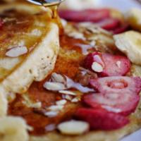 Bb Pancakes  (Til 4Pm · 3 pancakes mixed w banana, blueberry or strawberry and topped w shaved almonds & maple syrup