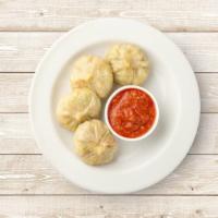 Veg Classic Dumplings · Boiled dumplings filled with chopped veggies and served with a side sauce.