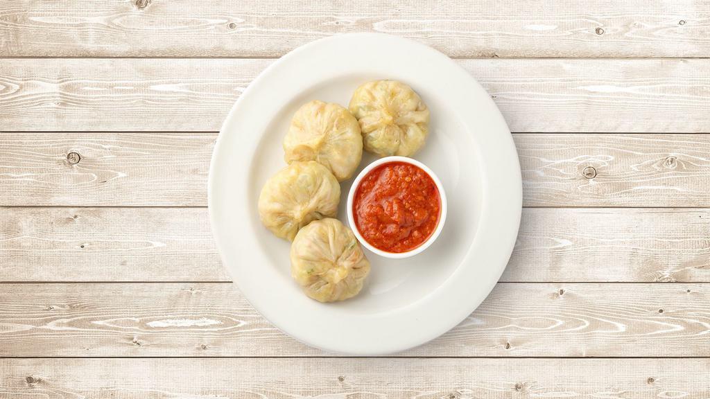 Veg Classic Dumplings · Boiled dumplings filled with chopped veggies and served with a side sauce.