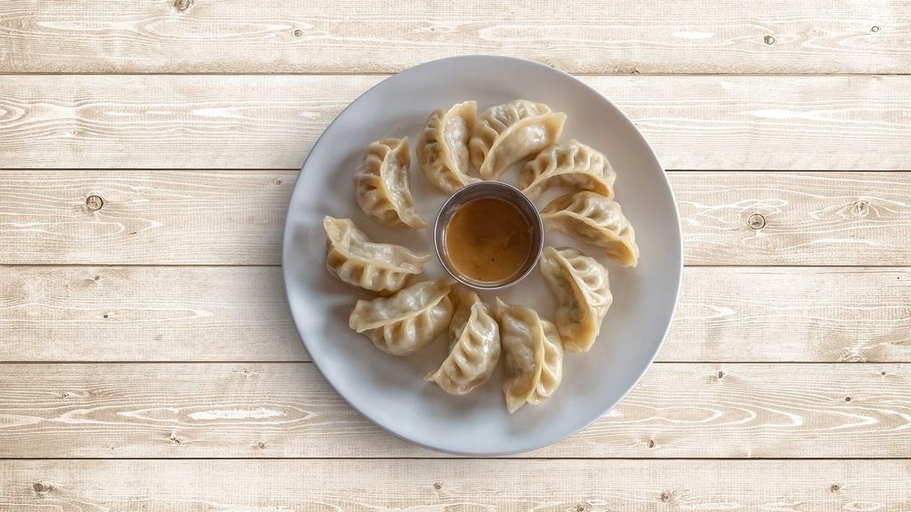 Chicken Classic Dumplings · Boiled dumplings filled with minced chicken and served with a side sauce.