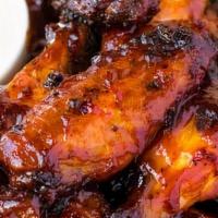 Bbq Chicken Wings · 6 pieces tossed in homemade BBQ sauce, gluten-free. Choice of homemade ranch or homemade blu...