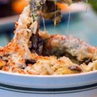 Truffle Mac · Shell pasta mixed with chef’s special blend, cremini mushrooms, whithe truffle oil, topped w...