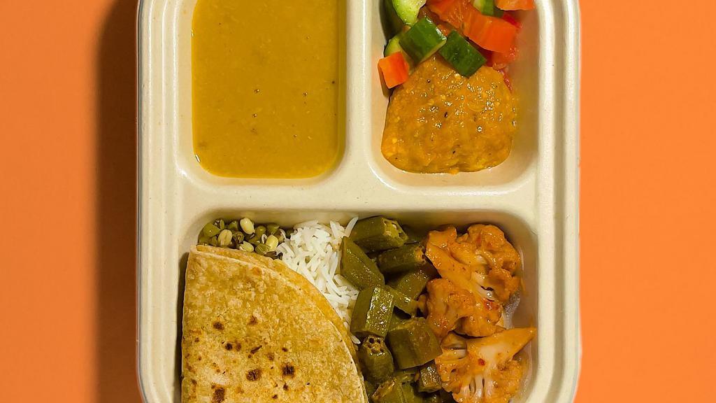 Veggie Plate · Okra, Spicy Indian Chinese Cauliflower, Moong Sprouts, Basmati Rice, small Roti (Whole Wheat Flatbread), Yellow Lentils, Eggplant Bharta and Kachumbar salad. Suitable for Vegan.