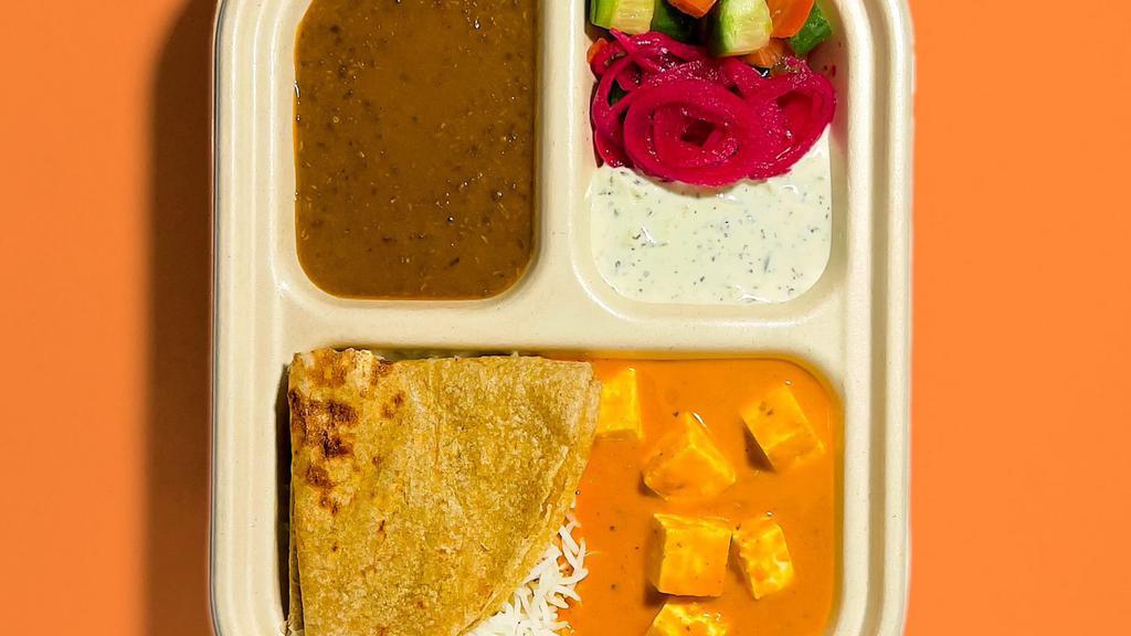 Paneer Tikka Masala Plate · Fresh Indian Cheese in a tomato cashew sauce, Basmati Rice, small Roti (Whole Wheat Flatbread), Black Lentils, Cucumber Yogurt, Pickled Onions and Kachumbar salad.