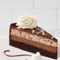 Chocolate Tuxedo Cheesecake · Layers of moist chocolate fudge cake, rich chocolate cheesecake, and vanilla mousse baked on...