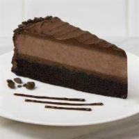 Hershey’S® Cheesecake  · Hershey’s® chocolate cake, layered with chocolate ganache and chocolate cheesecake, finished...
