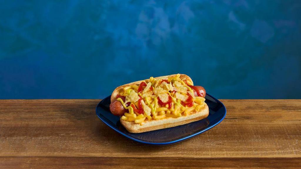 Kraft® Mac & Cheese Dog · Toasted bun stuffed with an all-beef hot dog and topped with KRAFT Mac & Cheese,  HEINZ® Ketchup and HEINZ® Mustard, and finished with crumbled potato chips