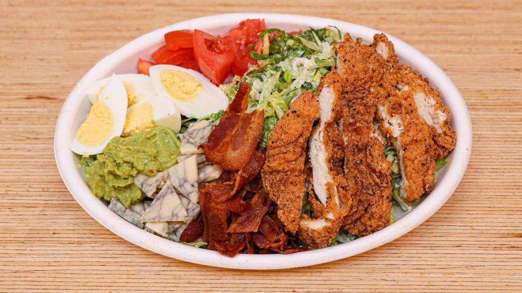 Cobb Salad · Crispy chicken, diced tomatoes, bacon, smashed avocado, boiled egg, lettuce, blue cheese, ranch dressing .