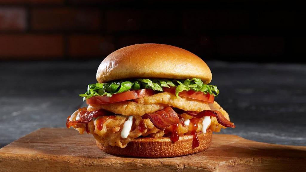 Bbq Bacon Tribeca · A 5 oz deep-fried chicken breast, BBQ sauce, onion rings, bacon, lettuce, and tomato.