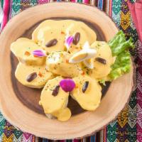 Papa A La Huancaina · Peruvian boiled potatoes served with creamy yellow feta cheese sauce.