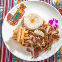 Lomo Saltado · Stir-fried dish sauteed with onions, tomatoes, and french fries served with rice.