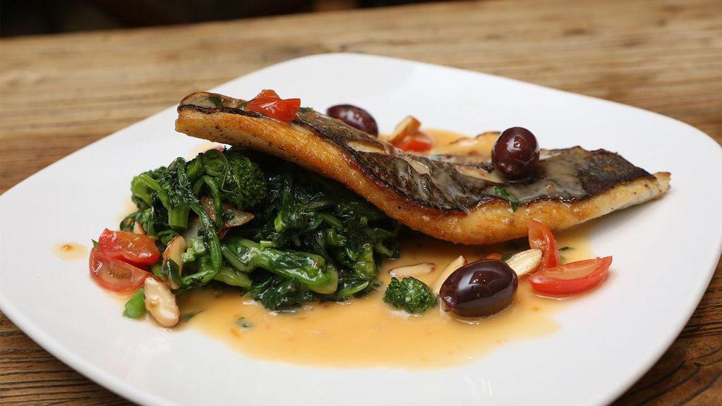 Pan-Seared Fillet Of Mediterranean Branzino · Cherry tomatoes, kalamata olives, toasted almonds, and broccoli rabe.