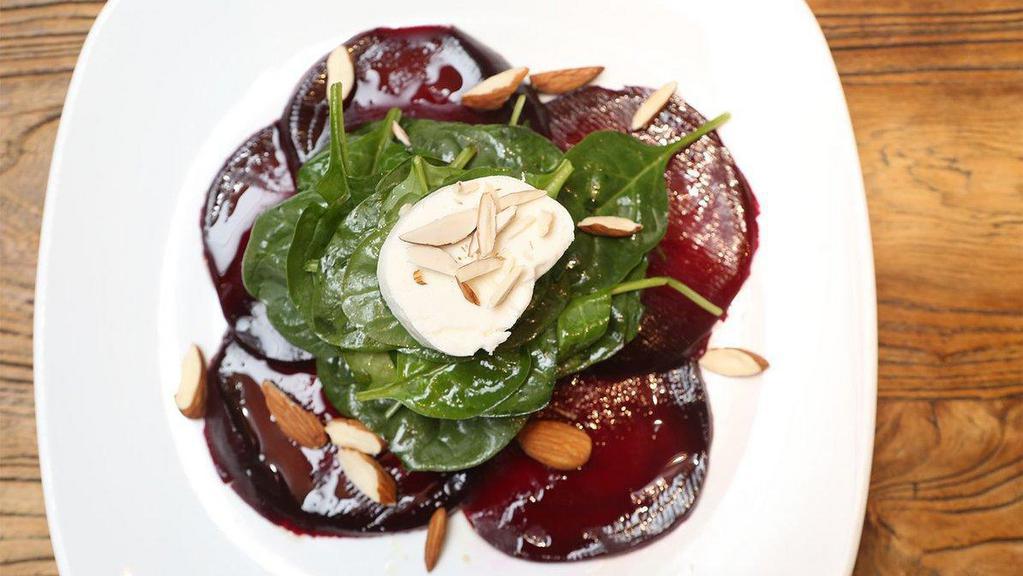 Red Beet Salad · Red beet carpaccio, baby spinach, goat cheese and toasted.