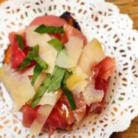 Pan Tumaca · Shaved tomatoes, manchego cheese, and prosciutto.