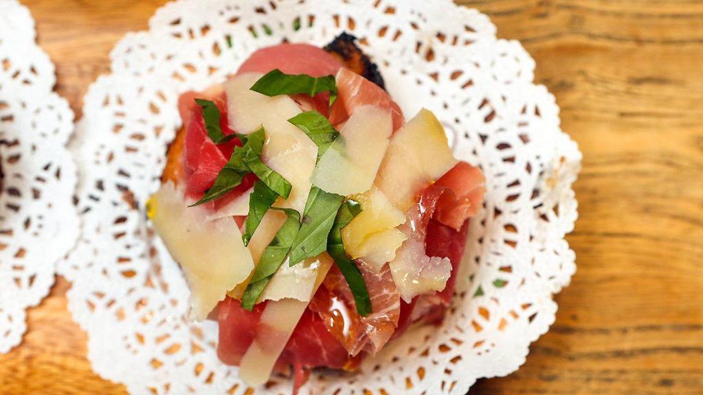 Pan Tumaca · Shaved tomatoes, manchego cheese, and prosciutto.
