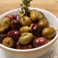 Mixed Olives · Mixed Mediterranean olives marinated in fresh rosemary, oregano, garlic, chili flakes, and E...