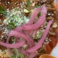 Tostada De Birria De Res (1) · crispy tortilla topped with monterey jack cheese, slow cooked shredded beef, onions, cilantr...