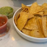 Chips With Guacamole & Salsa · Homemade tortilla chips served with a mild tomato salsa and guacamole.