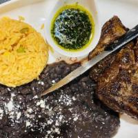Chimichurri Steak · Grilled skirt steak, with chimichurri sauce served with rice and beans.