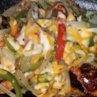 Fajitas · Sautéed beef strip or chicken, with onions, peppers, over rice on sizzler pan, served with f...
