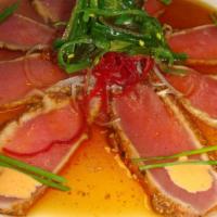 Pepper Tuna Appetizer · Slices of tuna seared with special pepper served with lemon vinaigrette.