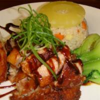 Crispy Duck With Pineapple Fried Rice · Half duck meat with brown sauce along with pineapple fried rice.