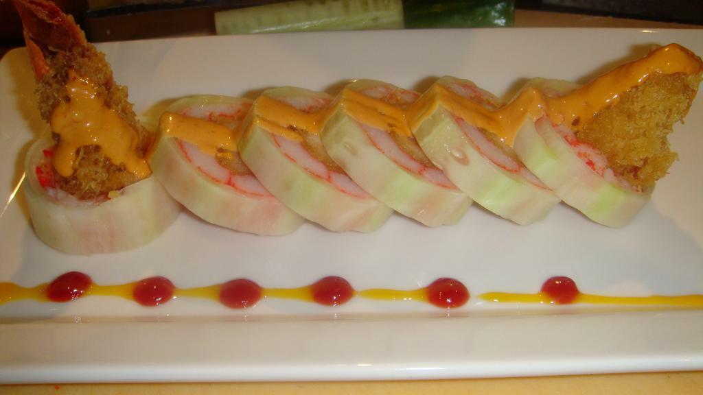 Bomb Roll · Lobster tail tempura and crab rolled thinly sliced cucumber. Served with spicy sauce.