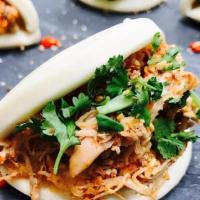 Red Curry Chicken Bao · Spicy. Red curry chicken, carrot, red onion, cilantro, crispy shallots and green sauce. Mild...